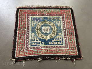 
A central Tibetan Khamdrum-style seating rug 66 x 71 cm. The partially visible border of red fabric is evidence of its use as a seating rug. There is a colour that could  ...