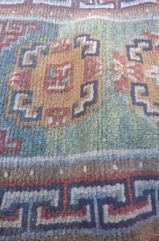 A wonderful tibetan Khaden from third quarter of 19th century.  All wool and vegetable dyes. Very good condition, no repairs 
119x66 cm so yes a bit smaller than usual.
Spectacular abrashes in  ...