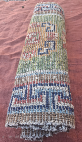 A wonderful tibetan Khaden from third quarter of 19th century.  All wool and vegetable dyes. Very good condition, no repairs 
119x66 cm so yes a bit smaller than usual.
Spectacular abrashes in  ...