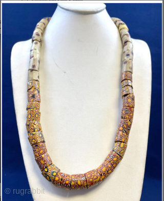 Millefiori African Trade Beads Necklace. Intricately designed mosaic-pattern glass beaded necklace with vibrant patterns. Age circa 1900.  Nearly 50 beads make up this necklace! 

These mosaic glass beads were used as  ...