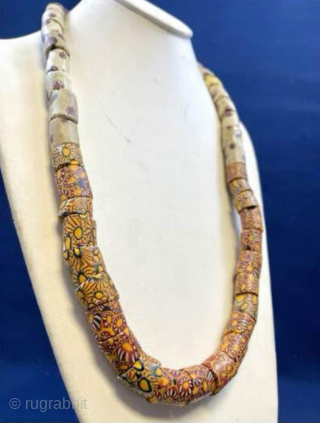 Millefiori African Trade Beads Necklace. Intricately designed mosaic-pattern glass beaded necklace with vibrant patterns. Age circa 1900.  Nearly 50 beads make up this necklace! 

These mosaic glass beads were used as  ...