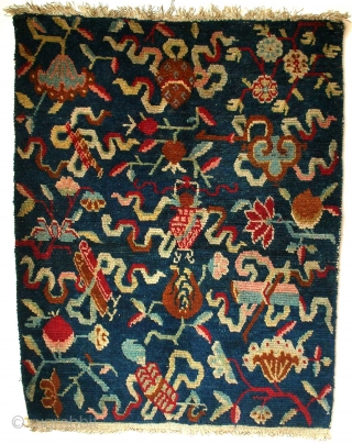 Jabuye, Tibet, late 19th century, cm 77x60. This pillow rug (jabuye) is quite an interesting one, for its overall design is a merry riot of motifs. This relates to the fact that  ...