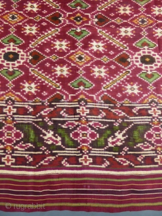 Early nineteenth century

India

Sumptuous red double silk woven shawl called Patola from India. Repetition of geometric patterns (hearts, flowers and stars) in cream, green and ocher drawing lozenges.
Borders of stripes and geometric friezes.  ...