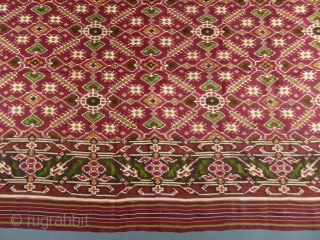 Early nineteenth century

India

Sumptuous red double silk woven shawl called Patola from India. Repetition of geometric patterns (hearts, flowers and stars) in cream, green and ocher drawing lozenges.
Borders of stripes and geometric friezes.  ...