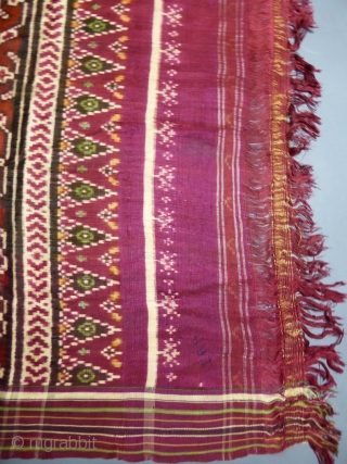 Early nineteenth century

India

Sumptuous red double silk woven shawl called Patola from India. Repetition of geometric patterns (hearts, flowers and stars) in cream, green and ocher drawing lozenges.
Borders of stripes and geometric friezes.  ...