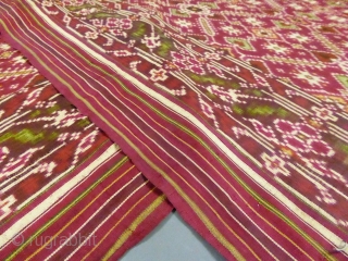 Early nineteenth century

India

Sumptuous red double silk woven shawl called Patola from India. Repetition of geometric patterns (hearts, flowers and stars) in cream, green and ocher drawing lozenges.
Borders of stripes and geometric friezes.  ...