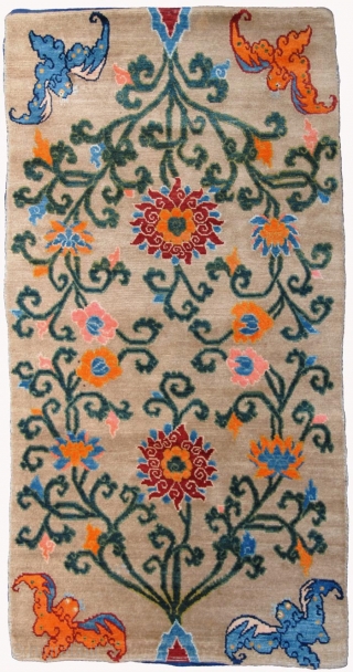 Beautiful Tibetan floral khaden (bed size rug) featuring two lotus’s - each growing out of Mount Meru, the mythical sacred mountain in Buddhist cosmology - with a bat ‘anchoring’ each of the  ...