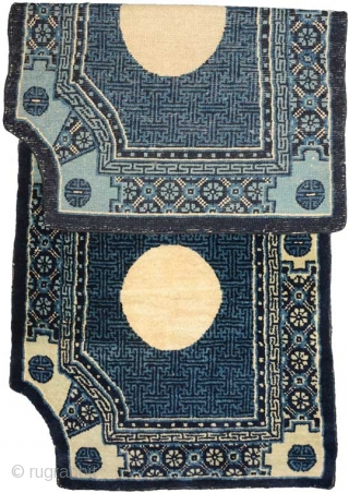 A magnificent scalloped-cornered under-saddle carpet made of the highest quality wool from Inner Mongolia (China), probably made in the Baotou area. The center field uses the running swastika design to good effect,  ...