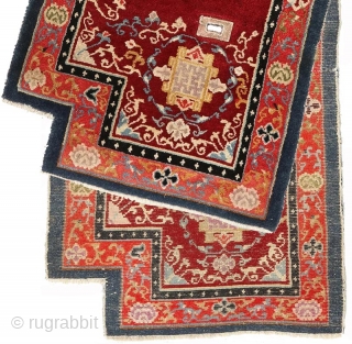 Striking Tibetan makden (‘under-saddle’ carpet) exhibiting a Khotan-like influence with an elaborate mandala motif surrounded by a fine trellis-like circular blue ‘necklace'. The main rose coloured outer border consist of alternating floral  ...