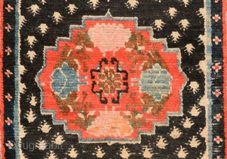 Strikingly vibrant Tibetan khaden with three medallions and the so-called 'frog foot' design scattered throughout the center field. The main border is a well executed interlocking yungdrung (swastika) design with an almost  ...