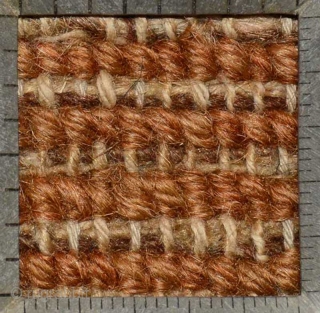 Tibetan khaden with various shades of blue making up the so-called 'gau box', or amulet, design evenly interspaced throughout the brown main field in 'lattice' like pattern. A 'Greek T' main border  ...