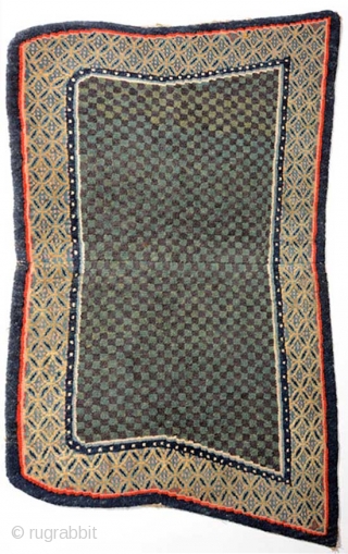 Tibetan under-saddle carpet (makden) of the so-called 'butterfly type', the shape of which is generally believed to have been 'introduced' by the Younghusband expedition to (i.e. the British invasion of) Tibet in  ...