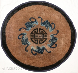 Small circular auspiciously designed rug from the Baotou / Suiyuan region of Inner Mongolia, with the central Shou symbol - the Chinese symbol of longevity - surrounded by a circle of five  ...