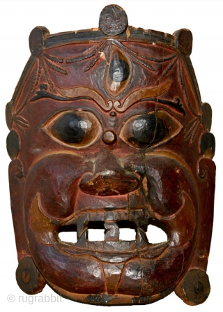 This beautifully hand carved wooden mask with a dynamic presence is from Tibet and is meant to depict the diety Mahakala, a 'Guardian of the Dharma' in the Tibetan Buddhist pantheon. His  ...