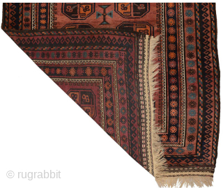 Captivating old burgundy coloured large Baluch, beautifully abrashed throughout and a main field featuring eighteen quirky unconventional octagonal guls / gols (i.e. medallion-like designs), which gives the carpet a charismatic eye-catching appeal.  ...