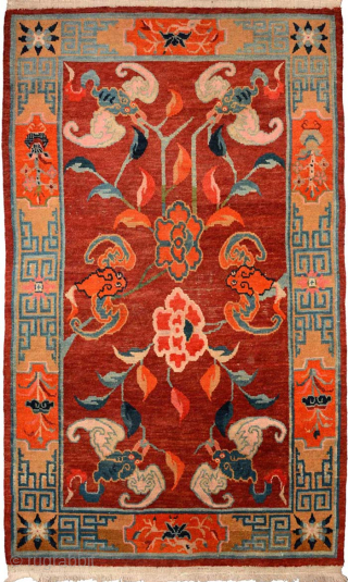 Tibetan khaden featuring six bats surrounding two central lotus flowers on a beautifully abrashed maroon-red main field, while the wide main border is of the 'section', or cartouche, type. It has wool  ...