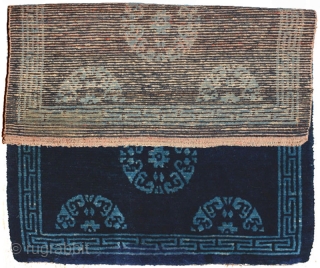 An elegant but subtle two-toned naturally dyed Tibetan seating carpet. A simple turquoise coloured ‘T’ border encases an uncomplicated dark blue central field set with turquoise rosettes, or roundels. It has good  ...