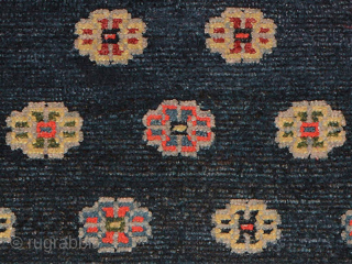 Impressive Tibetan khaden featuring multiple Khotanesque-like flower heads spread evenly throughout a deep indigo blue abrashed center field. All the dyes are natural, rich and saturated, the warp is cotton, while the  ...