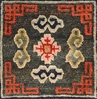 Beautiful richly coloured naturally dyed Tibetan seating carpet. The three dimensional 'Greek T' main border encloses an inner secondary border with crosses that mimic the tie-dyed tigma pattern much beloved by Tibetans,  ...