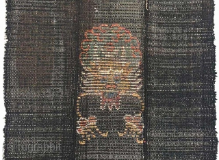 Tibetan three paneled black tsuktruk with a Zeepa (Dzeepa, Zeepak, et al) as the sole central motif, and with spray coming off a wave-like design set across the bottom. These blanket-like rugs are  ...