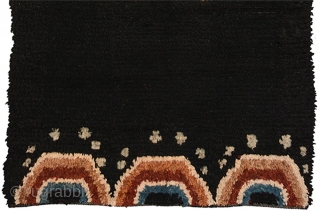 Tibetan three paneled black tsuktruk with a Zeepa (Dzeepa, Zeepak, et al) as the sole central motif, and with spray coming off a wave-like design set across the bottom. These blanket-like rugs are  ...