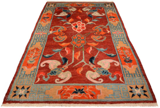 Tibetan khaden featuring six bats surrounding two central lotus flowers on a subtly abrashed maroon-red main field, while the wide main border is of the 'section', or cartouche type. Circa 1920 /  ...