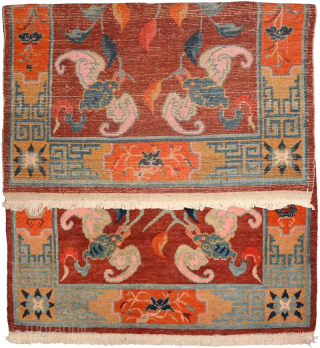 Tibetan khaden featuring six bats surrounding two central lotus flowers on a subtly abrashed maroon-red main field, while the wide main border is of the 'section', or cartouche type. Circa 1920 /  ...