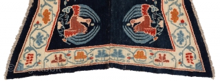 Beautiful 'butterfly' shaped under-saddle carpet from Tibet. The outer main border is of interlinked floral trellis work and has a peacock roundel as the main center field motif, which itself is a  ...