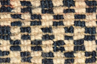 Tibetan masho (‘over-saddle’ carpet). Dark blue and white checkered center field, pearl inner border, 'rice grain' secondary border, Greek T outer border superimposed with beautiful flowers. Wool warp and weft. Circa 1920  ...