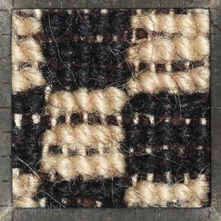 Tibetan 'butterfly-shaped' checkered makden, or under-saddle carpet. Black and white checkered center field, thin blue inner border, narrow black outer border. Circa 1920 with cotton warp and wool weft.  Size is;  ...