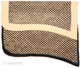 Tibetan 'butterfly-shaped' checkered makden, or under-saddle carpet. Black and white checkered center field, thin blue inner border, narrow black outer border. Circa 1920 with cotton warp and wool weft.  Size is;  ...