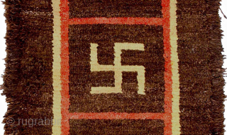 Striking yak wool ‘Wangden-style’ (i.e. warp-faced-back) Tibetan carpet displaying three auspicious yungdrung (swastika) motifs encased within three distinct design squares. It has a very thick natural brown soft yak wool pile and  ...