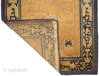 A very old Chinese carpet made in either the Ningxia or Beijing region in the 1700's / 18th century. The design in the golden-yellow center field is elegantly fashioned and features eight  ...