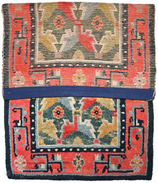 Striking Tibetan khaden with a lovely abrashed strawberry-red border and two shades of saturated abrashed green in the center field. A rare design ‘twist’ is the asymmetric nature of the design in  ...