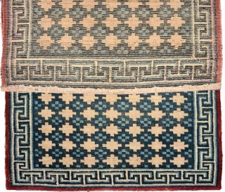 Mesmerizing early 1900’s Tibetan khaden with the so-called 'gau box' or amulet design throughout the main field. Coloured with only two blues and a thin red border, all naturally dyed, and what  ...