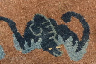 Small auspiciously designed circular rug from Inner Mongolia, i.e. the Baotou / Suiyuan region of China. The design features the central Shou symbol - the Chinese symbol of longevity - surrounded by  ...