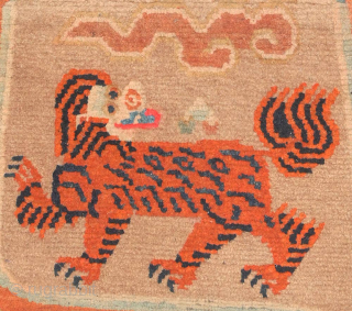 This Tibetan 'butterfly' shaped makden, or under-saddle carpet, features a rare depiction of tigers in place of the snow-lions sometimes seen in the same configuration (on makdens), while sinuous dragons encircle the  ...