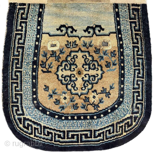 Attractive oval shaped Tibetan under-saddle carpet (makden) with mandala-like medallions, surrounded by simple floral displays, a secondary border with the lovely 'rice grain' pattern and a main outer border with the 'running ...