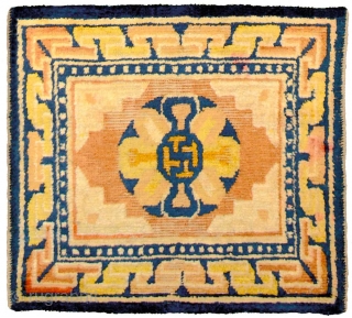 Ningxia mat with an outer main border that uses the 3D ‘T’ design and an inner border of pearls, and a single central swastika inside what may be a stylised 'double dorje'  ...