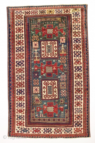 Antique kazak rug with remarkable design in excellent condition. Karachopf long rug elements along with a pair of large elegantly dressed people. Allover good even pile with good edges and ends. All  ...