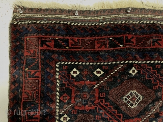 Antique Baluch bagface with an interesting older design. Fine lustrous pile with rich saturated natural color. Nice ember reds and a bit of yellow highlights. Mostly good thick pike with some brown  ...