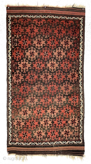 Antique small Baluch rug with very good design, excellent color and overall fair condition for the age. The array of archaic radiating medallions in diagonal bands on a lightly oxidized brown ground  ...