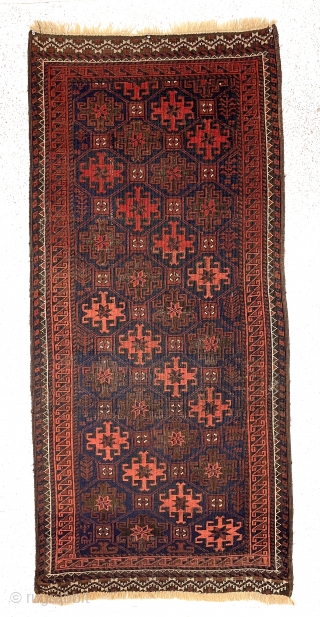 Antique blue ground Baluch rug with an unusual long narrow size, all over tile design and rare piled ends or skirt panels. All natural colors. Overall low pile with considerable oxidized browns.  ...