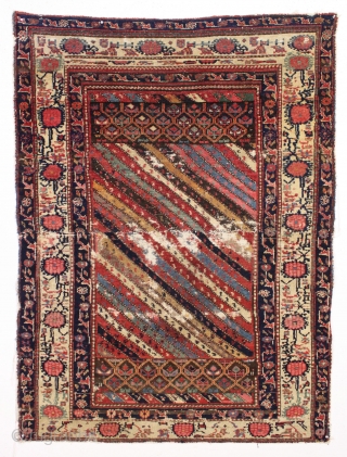 Large fragment of both ends of a beautiful old northwest Persian rug. Interesting design and all natural colors featuring a lovely old purple. Reasonably clean. ca. 1875. 4'4" x 5'10"   