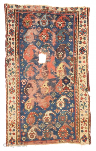 Antique little caucasian rug with an unusual border, unfortunately, ravaged by wolves. Interesting older piece, probably kazak. All natural colors featuring an unusually nice yellow. "as found". 3rd quarter 19th c. 2'8"  ...