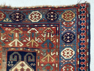 Antique Caucasian Kazak or karrabagh rug with an interesting and archaic design. Pretty light blue border. Some decent pile but essentially ravaged by wolves condition. Wear, tears, stains, black oxidation, edge gouges  ...