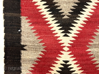 Older little Navajo weaving. Saddle blanket? Pretty natural wool colors and a rich saturated red. No color run. Fair condition for age. I see a couple small dime sized holes in border.  ...