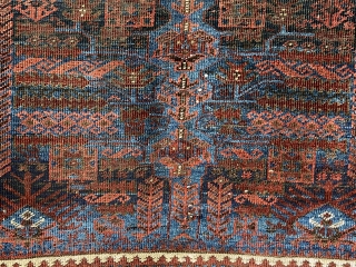 Early blue ground timuri Baluch rug with vivid electric blues. Unusual field design with archaic floral motifs and a beautifully drawn central medallion. All natural colors. Thin and floppy with very fine  ...