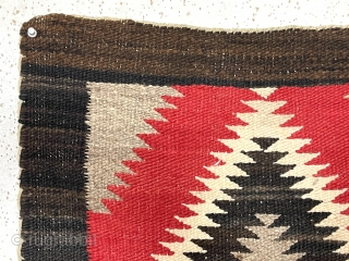 Older little Navajo weaving. Saddle blanket? Pretty natural wool colors and a rich saturated red. No color run. Fair condition for age. I see a couple small dime sized holes in border.  ...