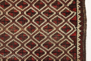 Antique tiny Baluch rug with an unusual allover design. All natural colors. "as found", with some wear as shown but original sides and ends. Reasonably clean with a small old stain as  ...